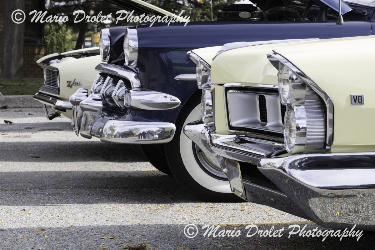 Quarter view of 3 cars' front end in colour