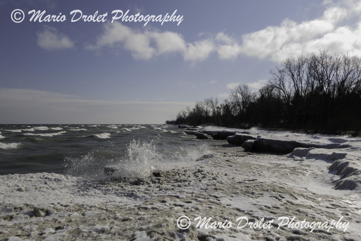 Waves crashing over ice on the lake shores
