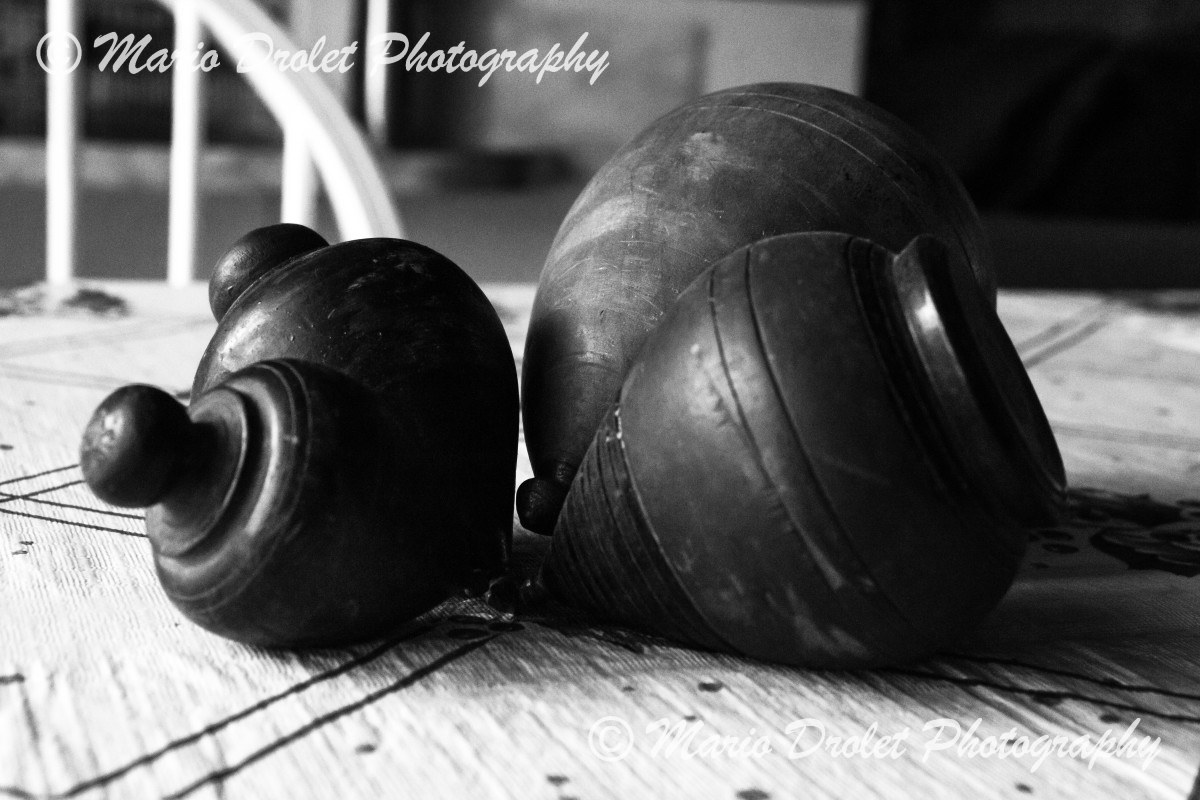 Spin tops resting on a table with dark background