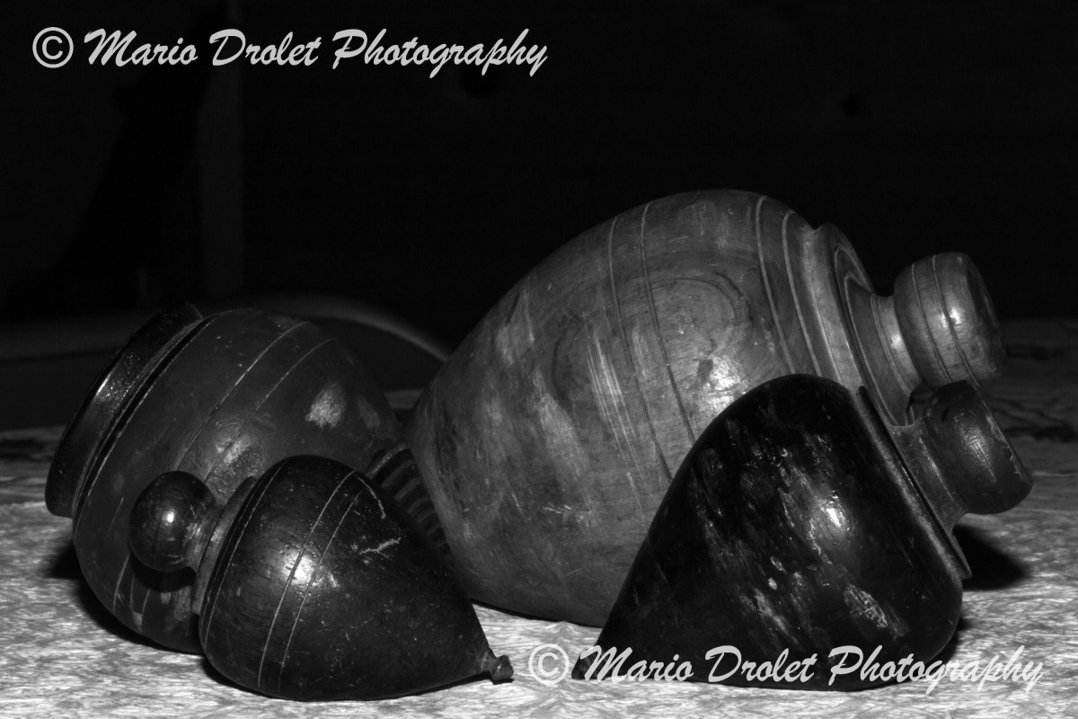 Spin tops resting on a table with dark background