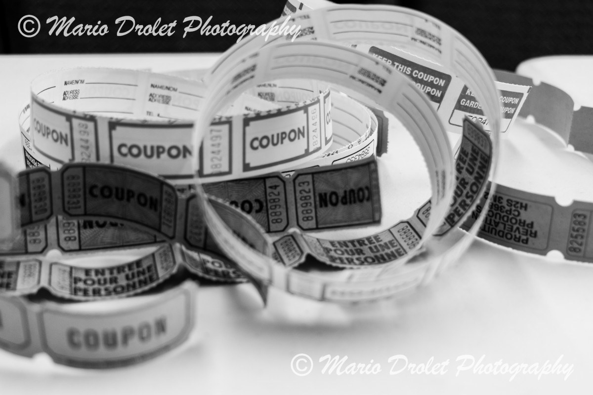 Black and white photo of unrolled raffle tickets