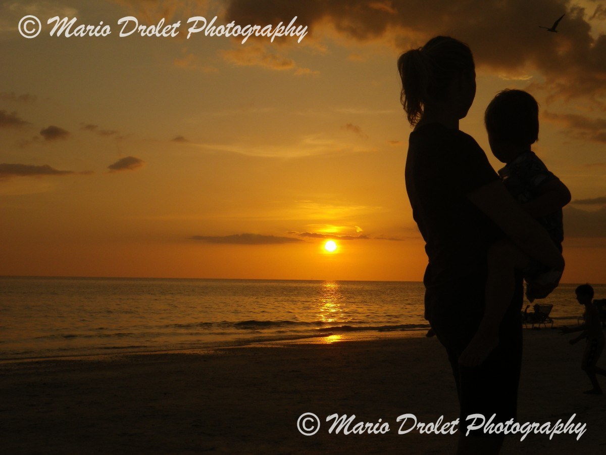 People's silhouette at sunset over Lido Beach