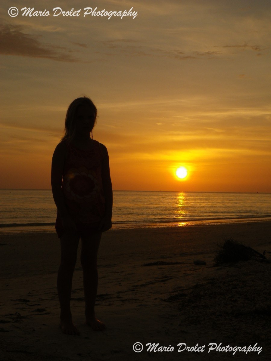 People's silhouette at sunset over Lido Beach
