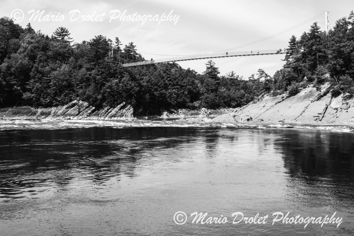 Suspended bridge over chaudiere river in Quebec, Canada in black and white