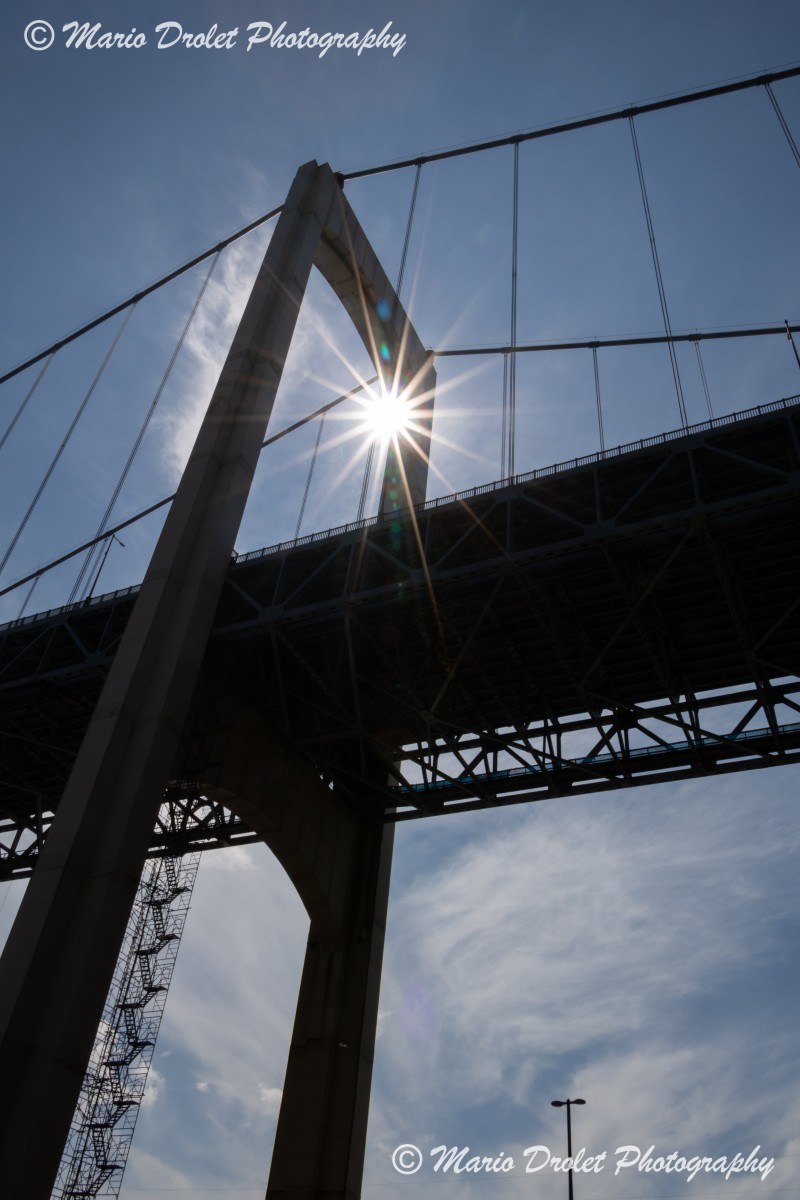 Sunflare through the arch of Pont Pierre Laporte in Quebec city